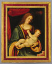 
A woman gazes at a baby in her lap. He reaches up with his left hand to clutch her necklace.