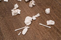 
White porcelain objects scattered on a wood floor.