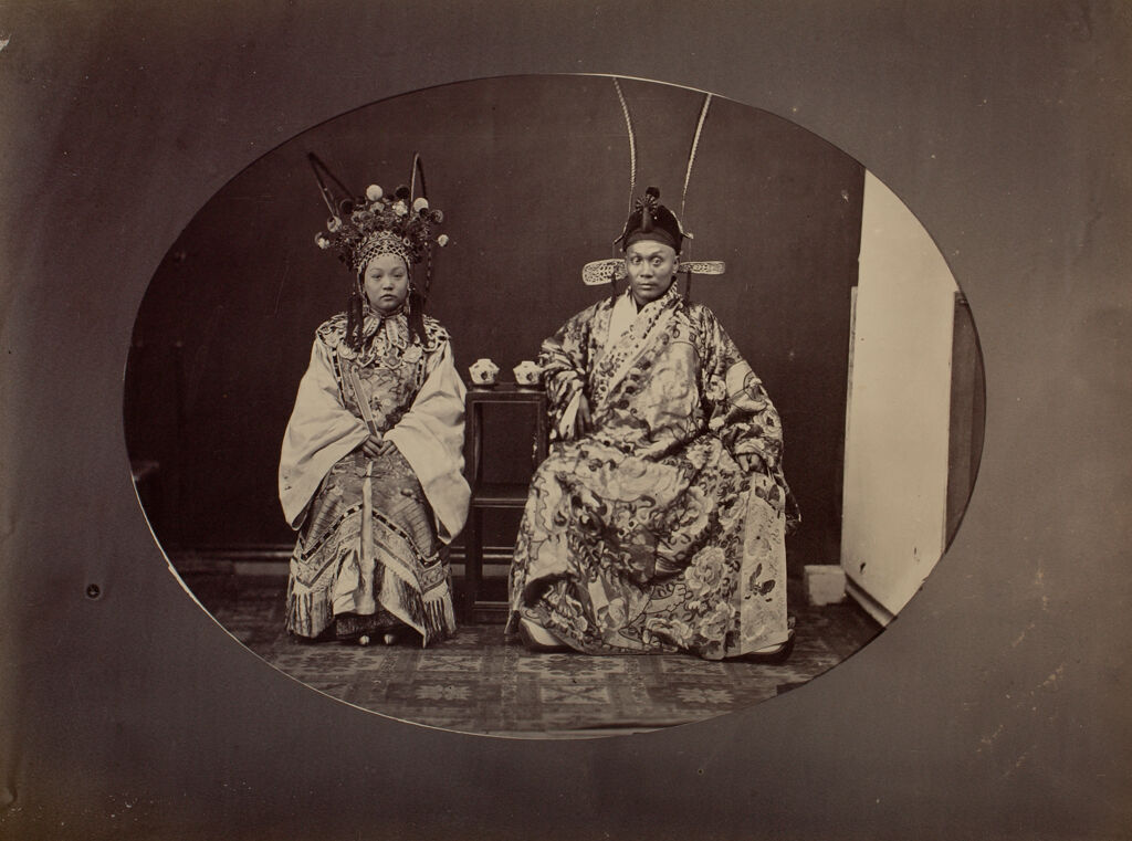 Woman And Man Posing In Chinese Opera Costumes