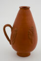 Orange-colored, one handled flask with narrow mouth, long, pear-shaped body with two raised decorations, and small round base 