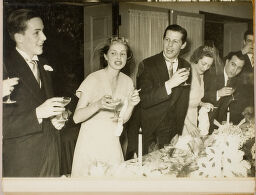 Untitled (Wedding Guests Standing With Drinks In Hand At Dinner Table)