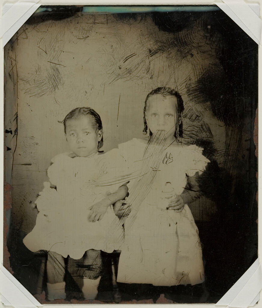 Untitled (Two Young Girls, One Seated And One Standing, Both Holding Dolls, Three-Quarter View)