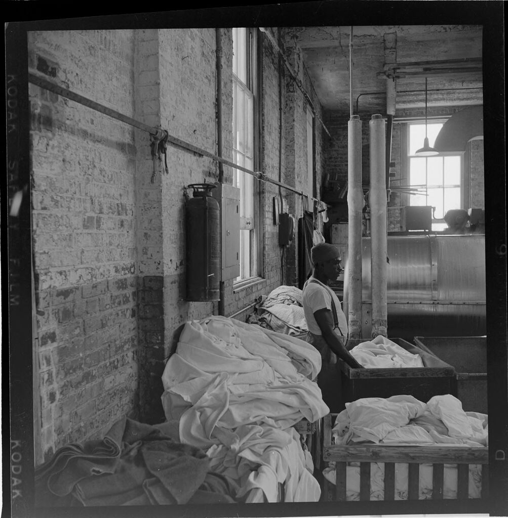 Untitled (Man With Laundry Piles; Woman Sitting On Chair By Phone)