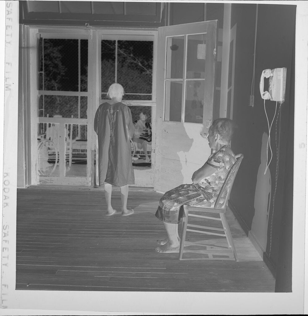 Untitled (Woman Sitting On Chair By Phone)