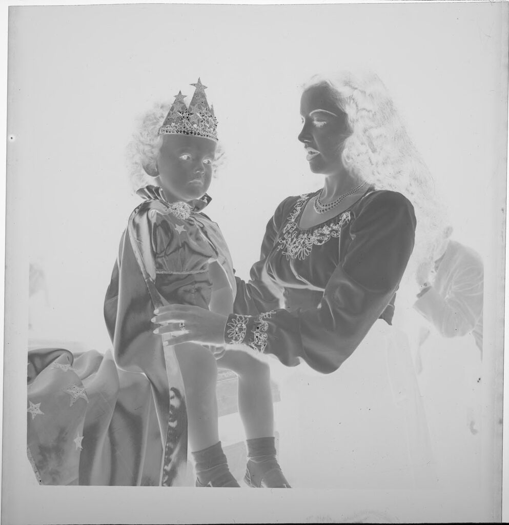 Untitled (Woman Holding Girl Who Is Dressed Up As Queen)