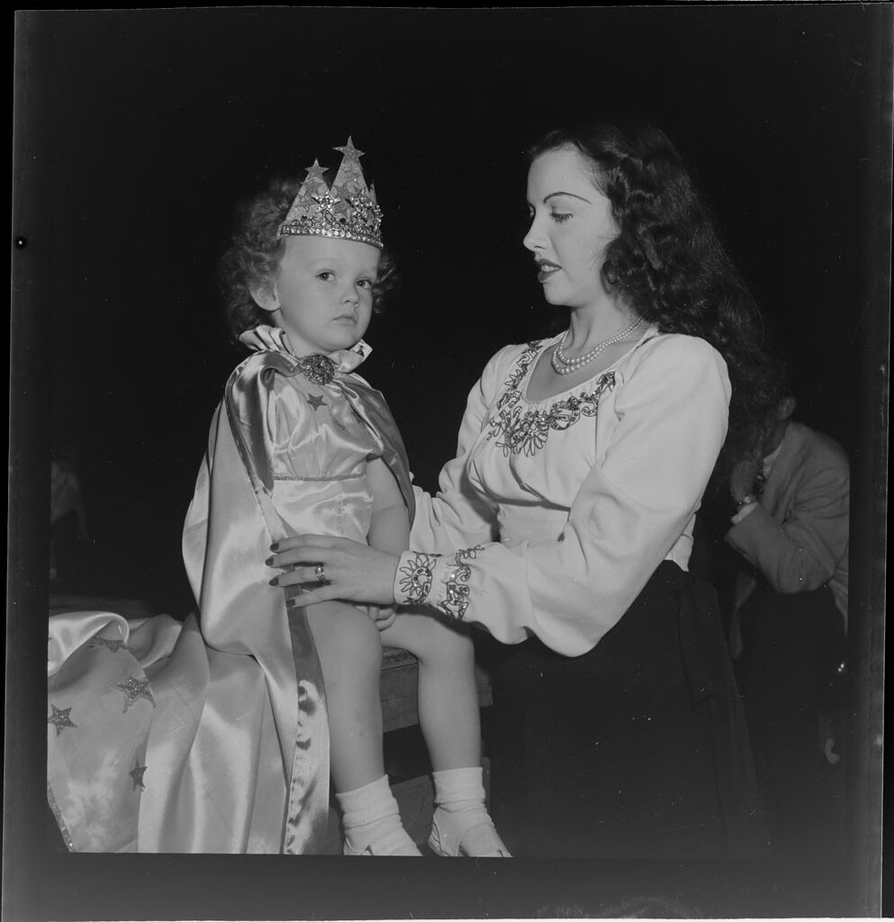 Untitled (Parents Holding Children Who Are Dressed Up As King And Queen)