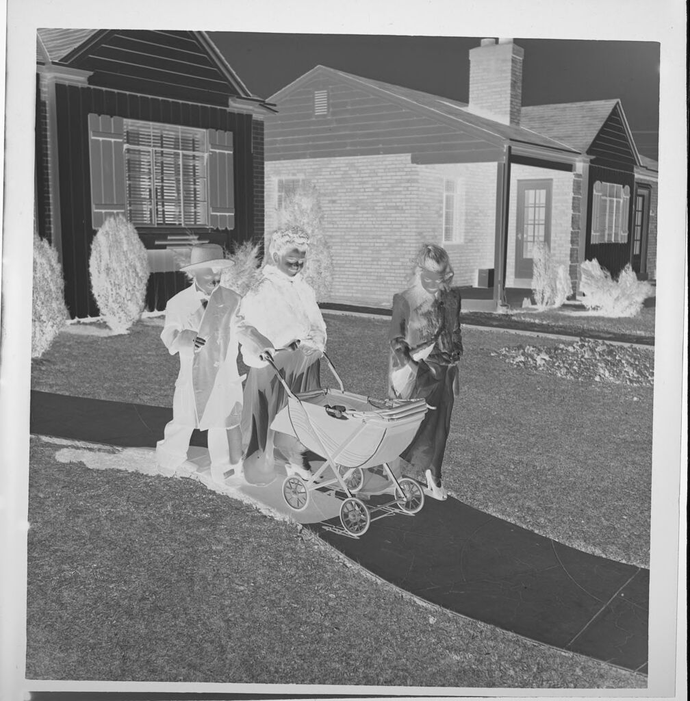 Untitled (Children Playing Dress-Up And Walking Baby Carraige On Sidewalk)