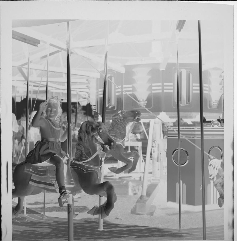 Untitled (Girl Riding On Carousel Horse)