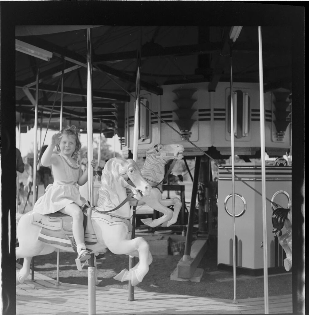Untitled (Girl Riding On Carousel Horse)