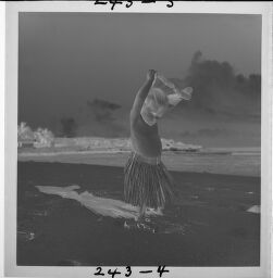 Untitled (Small Child On Beach In Grass Skirt And Lei)