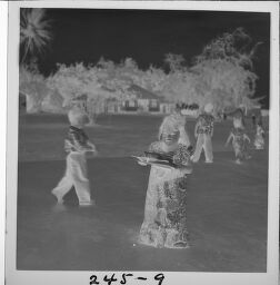 Untitled (Girl In Hawaiian Dress Holding Boxes)