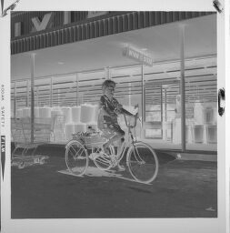 Untitled (Woman On Bicycle In Front Of Winn Dixie)