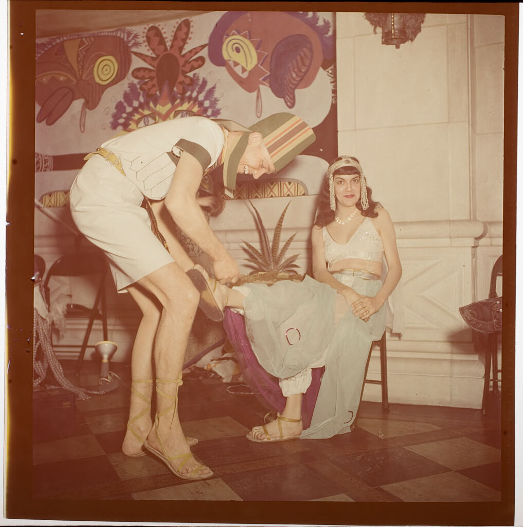 Untitled (Couple In Costume At Beaux Arts Ball, Man Fixing Woman's Shoe)