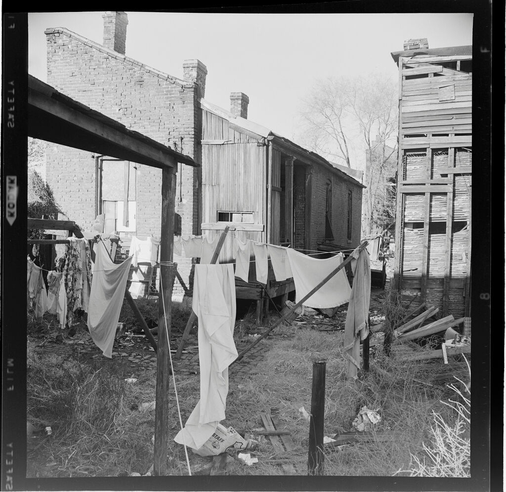 Untitled (Laundry Hanging Behind Small House)