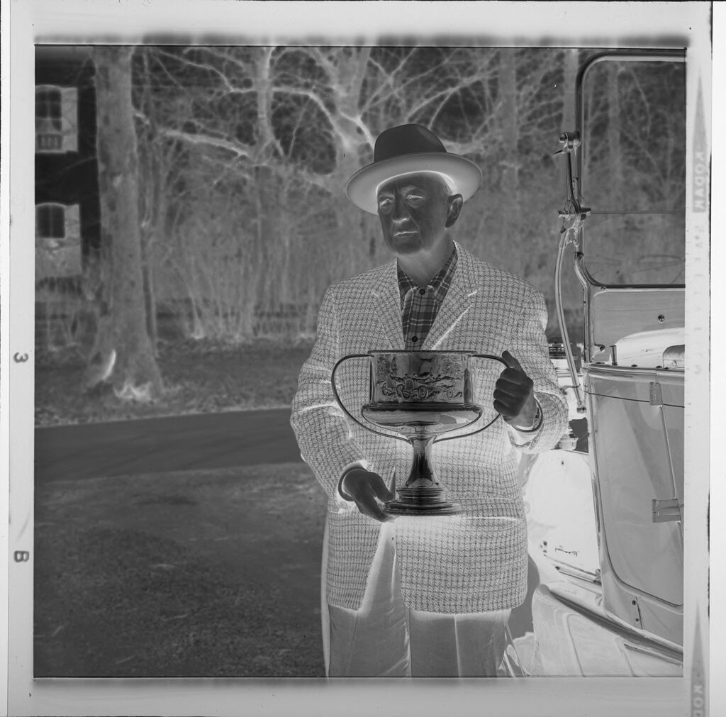 Untitled (Man With Trophy Standing Next To Old Car)