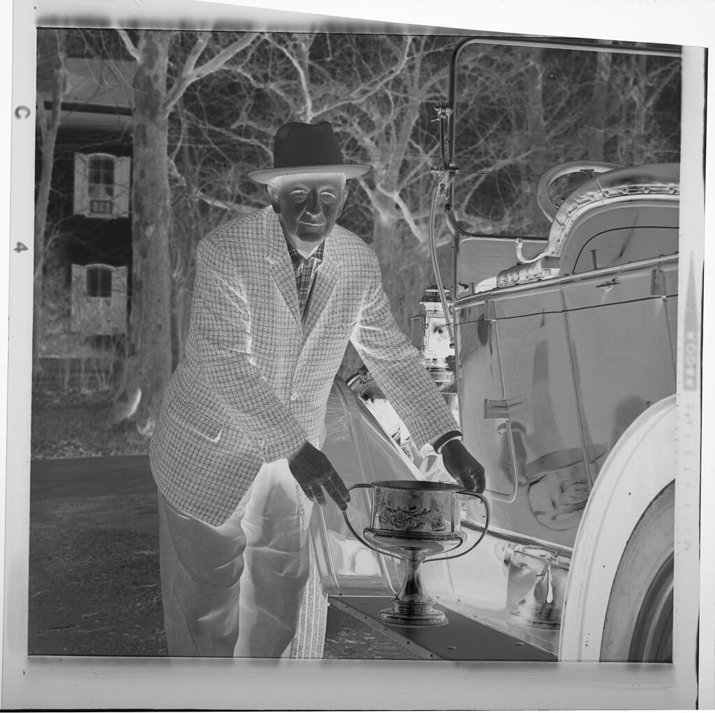 Untitled (Man With Trophy Standing Next To Old Car)