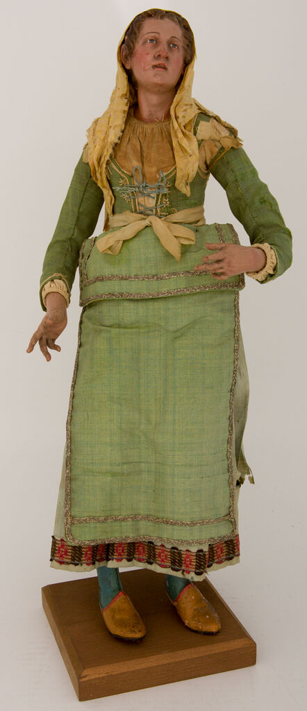 Woman With Yellow Silk Headscarf, Green Laced Bodice, And Green Apron
