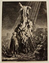 The lifeless body of a man is lowered off the cross by four men, people look on from the ground.