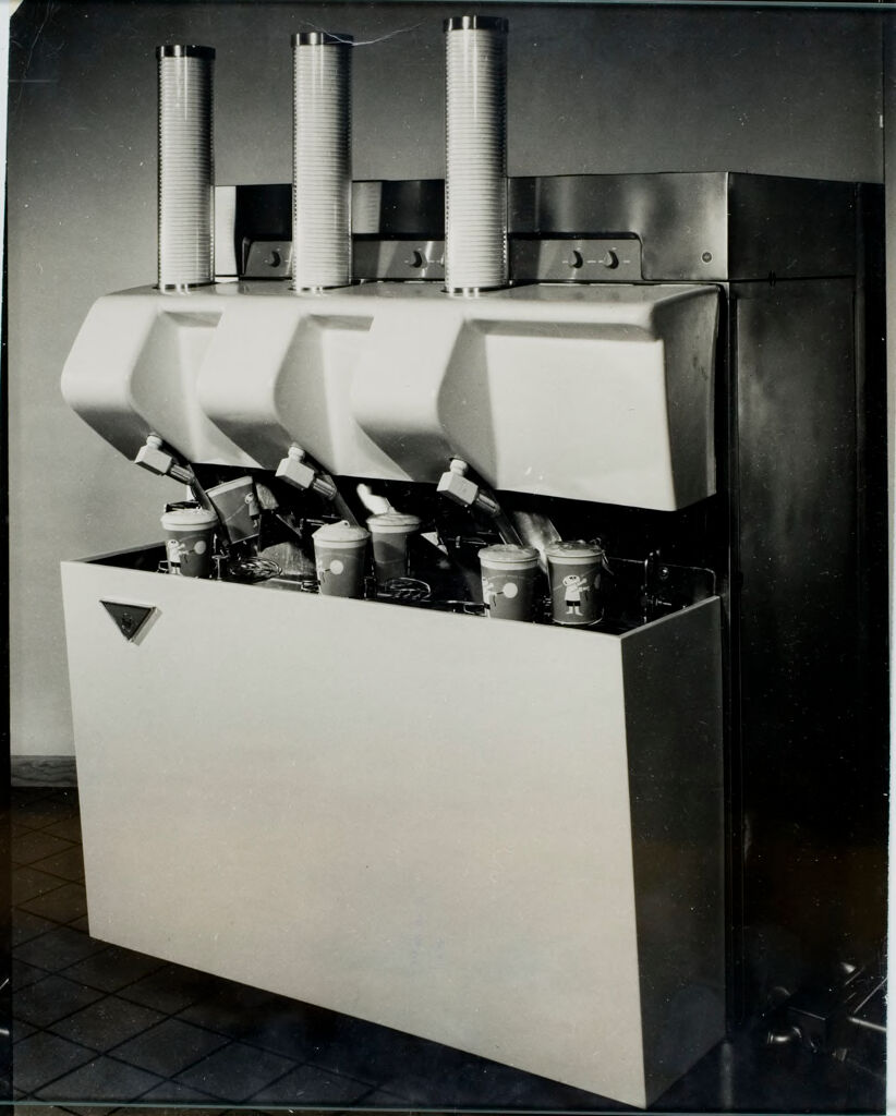 World's First Fully Automated Restaurant (Fifth Of Eight): Any Of Three Flavors Can Be Dispensed As Ordered By This Automatic Milk Shake Machine Located Conveniently Near The Amfare System Central Assembly Point.  A Cup Is Dispensed, Filled With The Shake Until The Flow Is Automatically Stopped By Electric Eye, Then Rotated To Allow The Next Shake To Be Made.