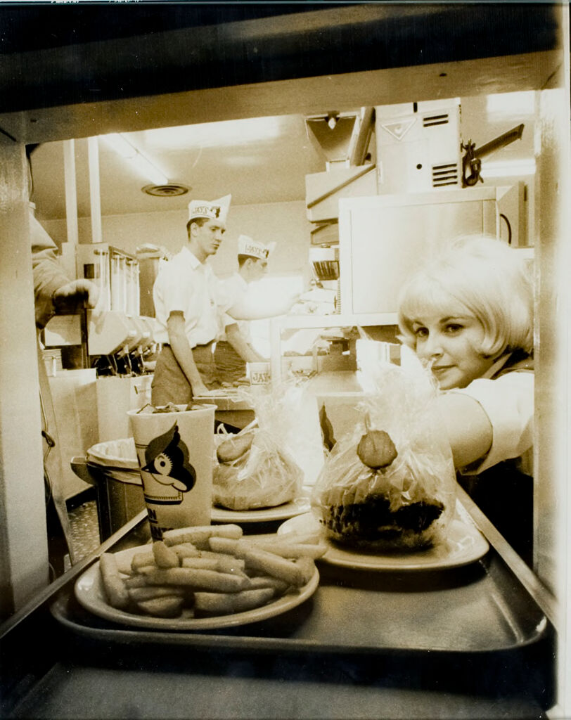 World's First Fully Automated Restaurant (Seventh Of Eight): A Tray Of Automatically Prepared Food Leaves The Kitchen En Route To The Dining Room By Conveyor Belt After The Individual Food Items Were Collected By Order Boys (Background) And Placed On A Tray With The Check.  The Tray Is Carried By Carhops To The Cars.