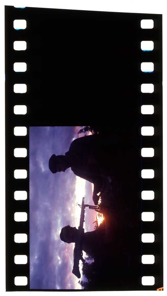 Untitled (Soldier With Gun On Shoulder And Officer Silhouetted Against Setting Sun And Clouds, Vietnam; [Blank])