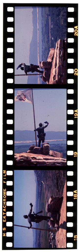 Untitled (Soldier Standing With Flag On Hilltop Overlooking Landscape, Vietnam)