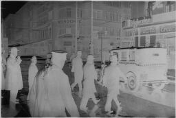 [Group Of Men Walking Toward Car, Berlin]