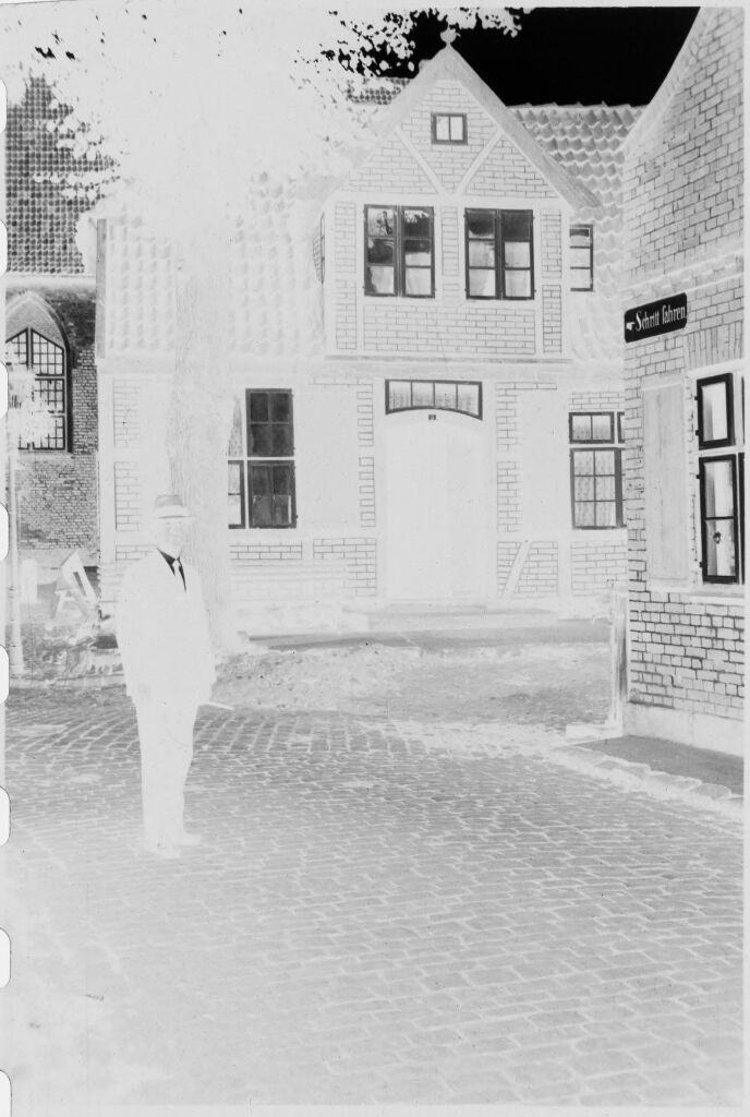 [Man Walking In Evening Light By Houses Near Lübeck]