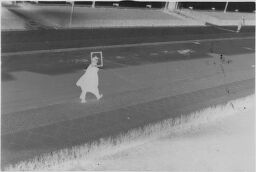 [Lux Feininger Walking Down Street Looking Through Empty Picture Frame, Siemensstadt]