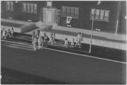 [View From Above Of People Walking In Front Of Building With Nazi Flag, Siemensstadt]
