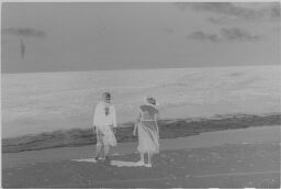 [Two Women On Beach At Water's Edge]
