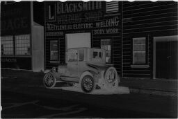 [Car In Front Of Blacksmith Shop]
