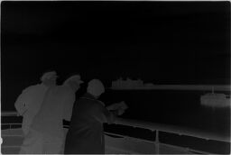[Two Uniformed Men And Woman Learning Against Ship Railing]