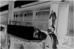 [Men Working On Train, Julia Feininger In Foreground]