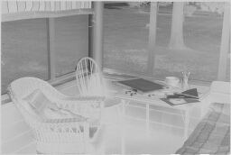 [Bed, Chairs And Table In Screened Porch]