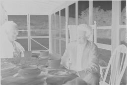 [Unidentified Man And Julia Feininger On Screened Porch]