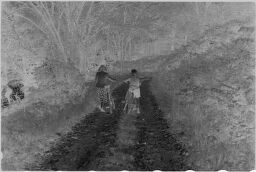 [Two Women Riding Bicycles On Dirt Road]