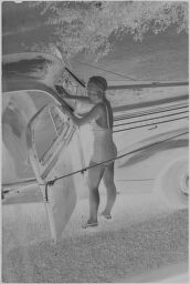 [Women In Bathing Suit Next To Car]