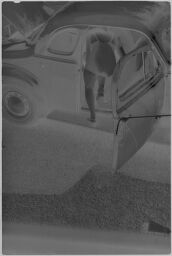 [Woman In Bathing Suit Getting Into Car]
