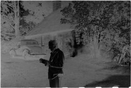 [Unknown Man In Front Of Stone House]