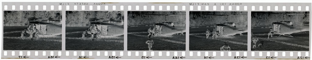 Untitled (Soldiers Directing Arrival Of Helicopter In Field; Unloading Supplies, Vietnam)