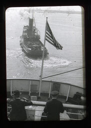[Flag, Tugboat, Passengers On Ship Deck]