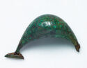 A hollow crescent shaped piece of dark metal with a triangular piece of the same metal extending from the left terminus.