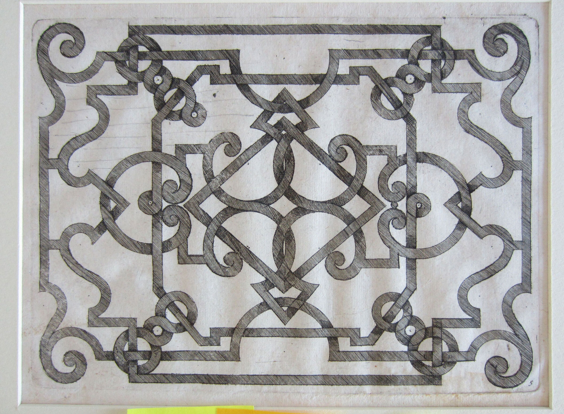 Interlace With Scrolls At Corners, Centered By A Horizontal Lozenge