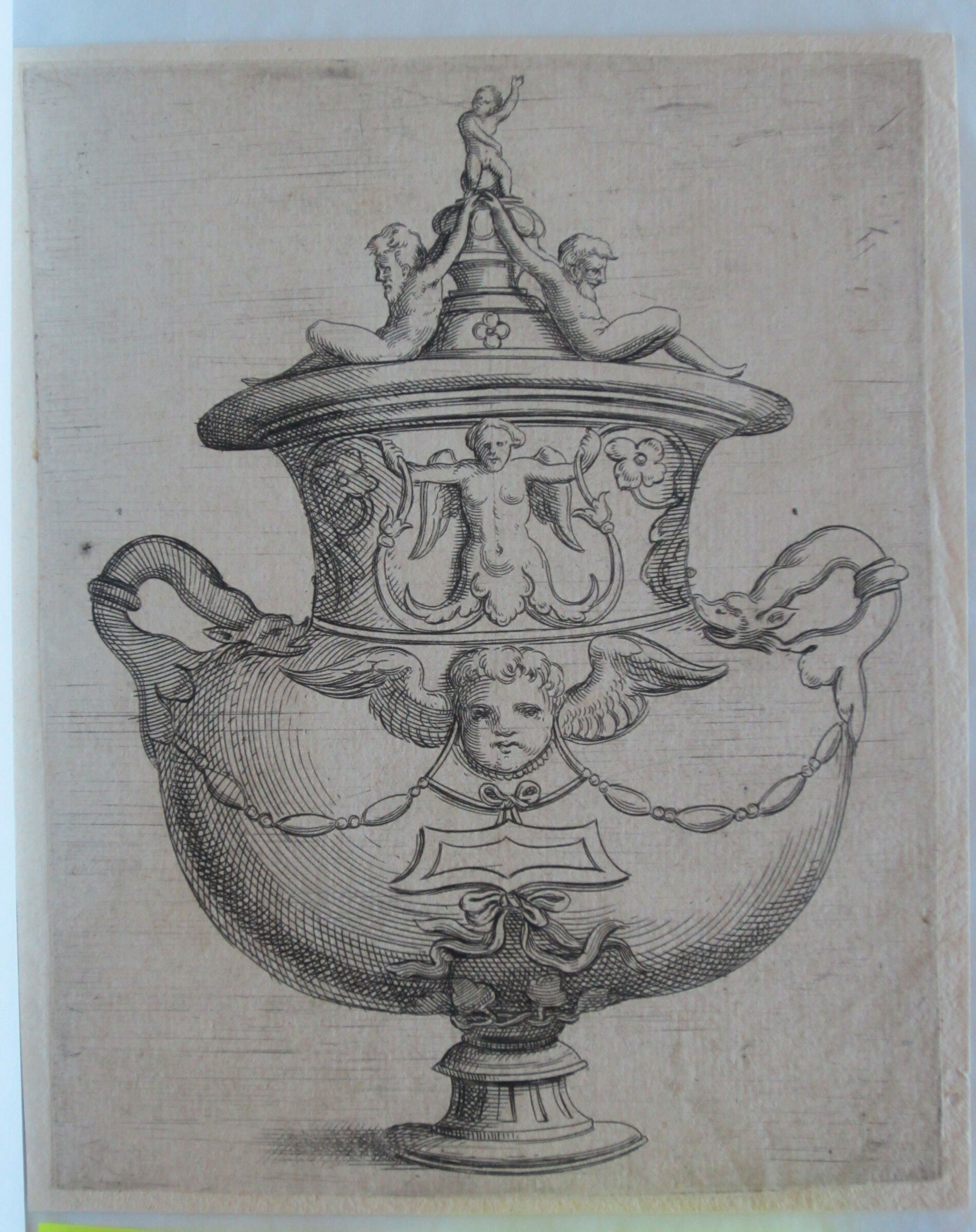 Covered Two-Handled Vase With A Winged Putto's Head Suspending A Tablet