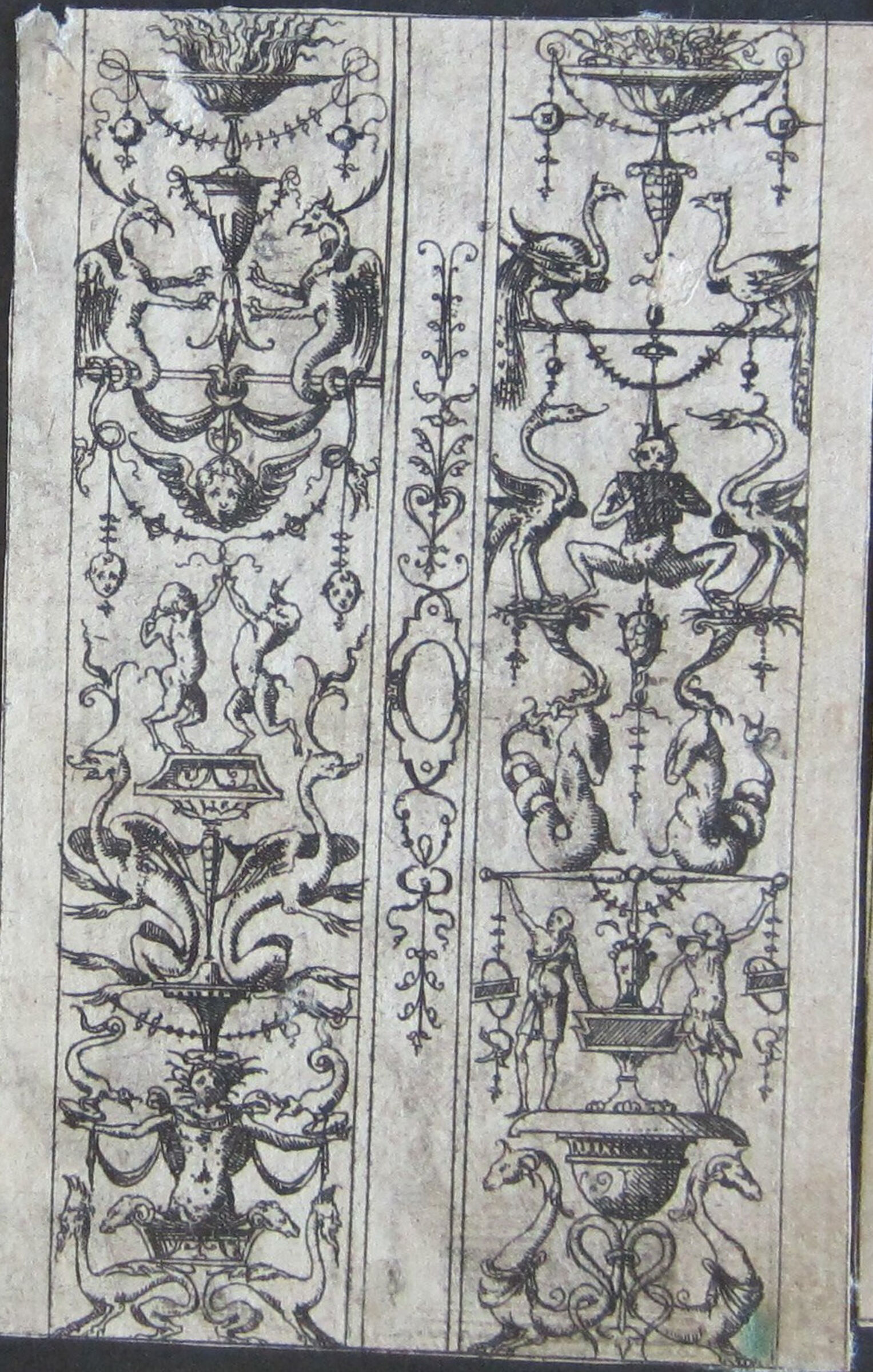 Two Grotesques Separated By A Vertical Band Of Ornament, The Left Grotesque With Dancing Satyrs