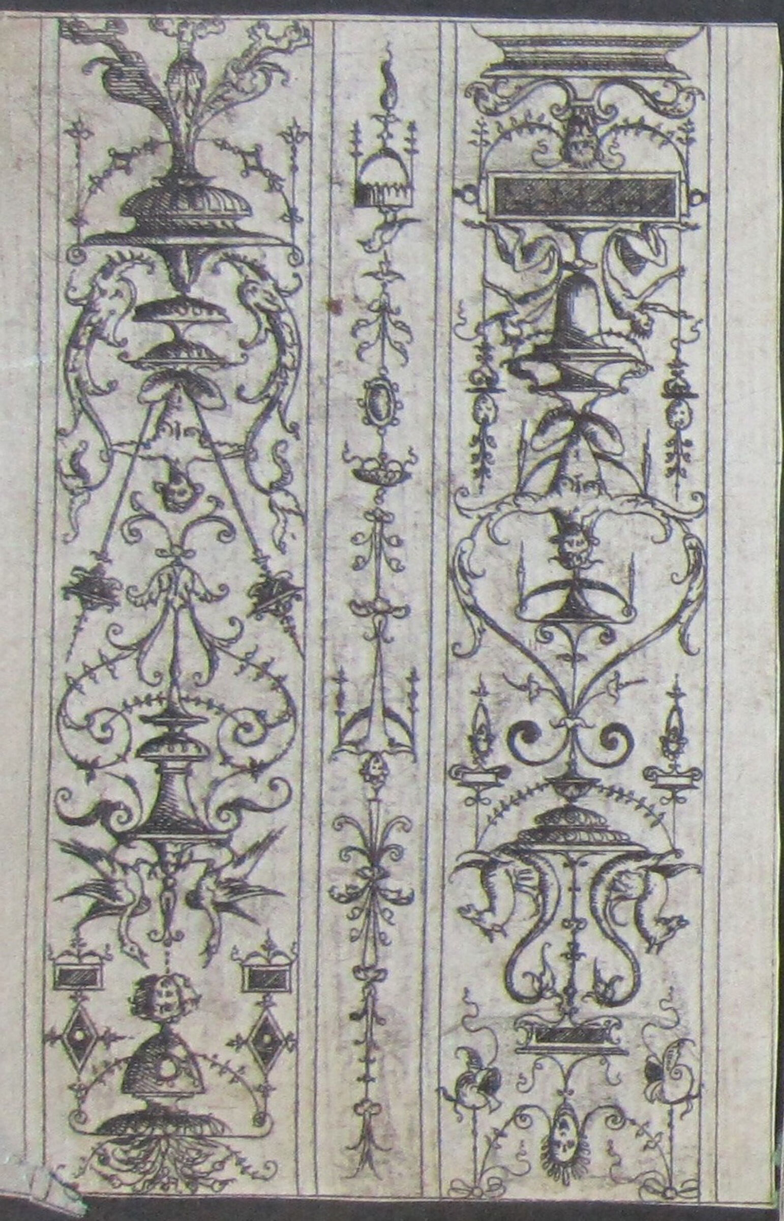 Two Grotesques Separated By A Band Of Ornament, Each Grotesque With A Figure Squatting On A Tiered Vase