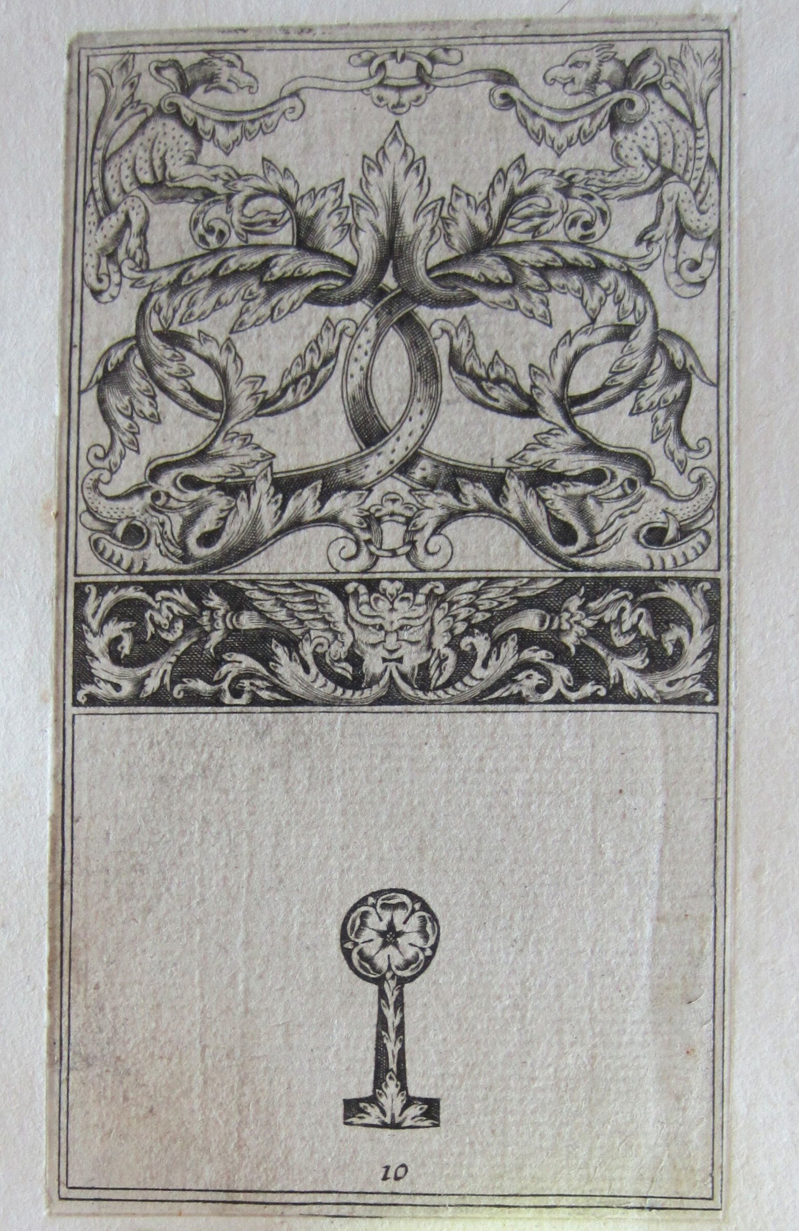 Foliate Interlace With Two Monstrous Animals, Frieze With A Winged Satyr's Mask, The Keyhole Below With A Rose