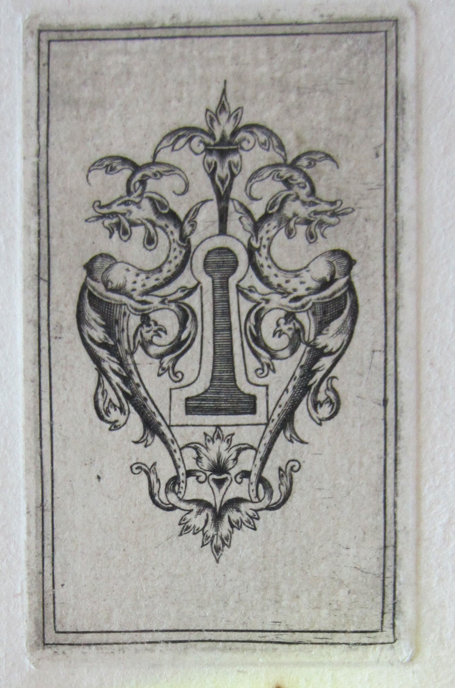 Escutcheon With A Shaded Keyhole Flanked By Two Crouching Long-Tailed Dappled Monsters