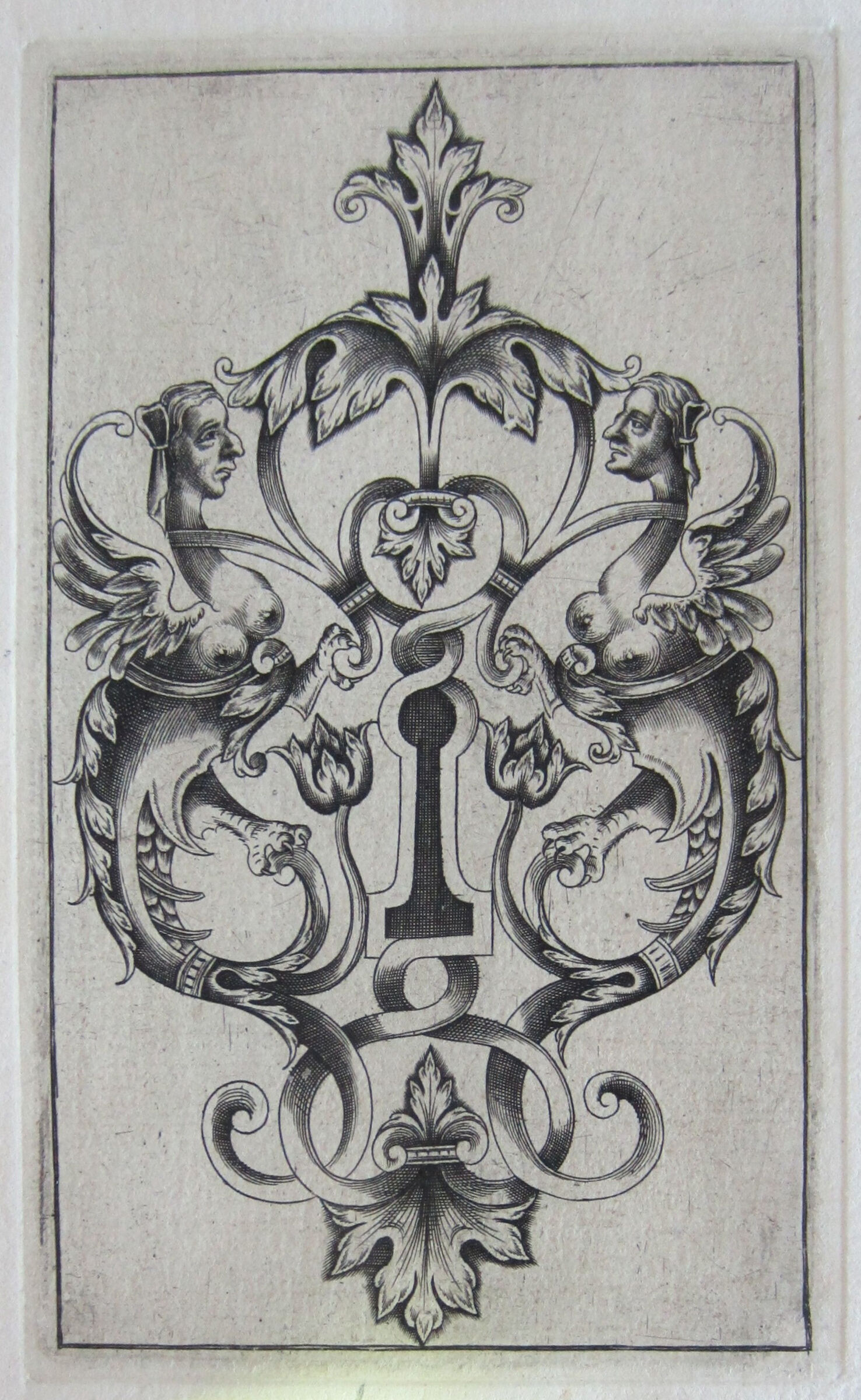 Escutcheon With A Shaded Keyhole Flanked By Two Winged Female Monsters Grasping Tendrils With Their Paws